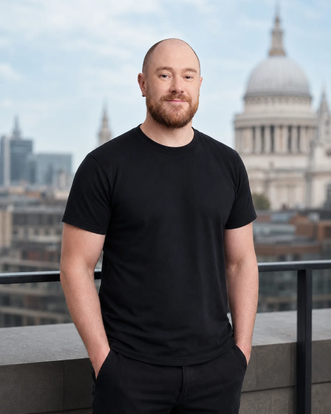 Hugh Reinbolt standing on a London terrace, with St Paul's Cathedral behind him.